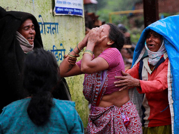 Relatives wail after seeing the body of a victim