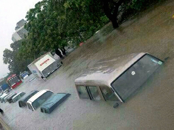 Vehicles stuck at a flooded road during heavy rains