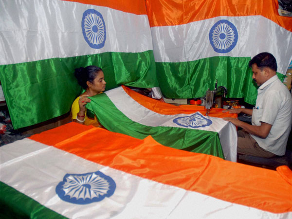 A tailor stitching the Indian National flag A tailor stitching the Indian National flag