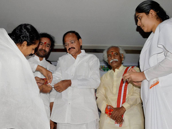 Brahma Kumari's tying rakhi on the wrist of Union Minister M.Venkaiah Naidu