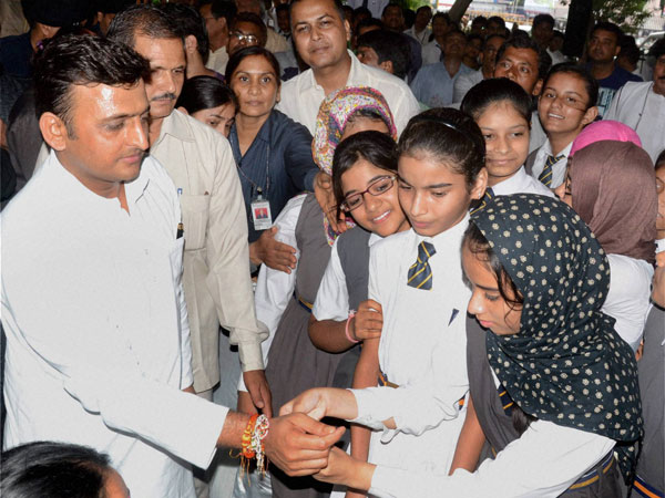 Girls tying rakhi to UP Chief Minister Akhilesh Yadav
