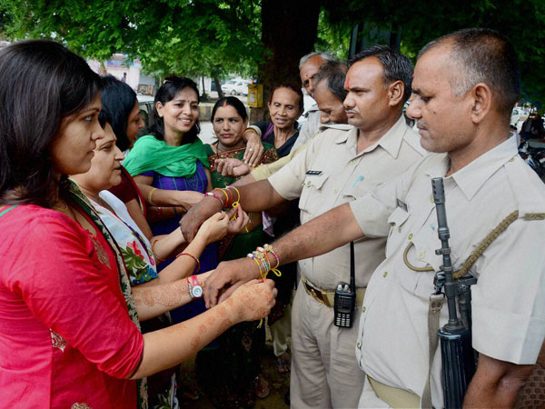 Women tying rakhis on policemen on the occasion of Raksha Bandhan