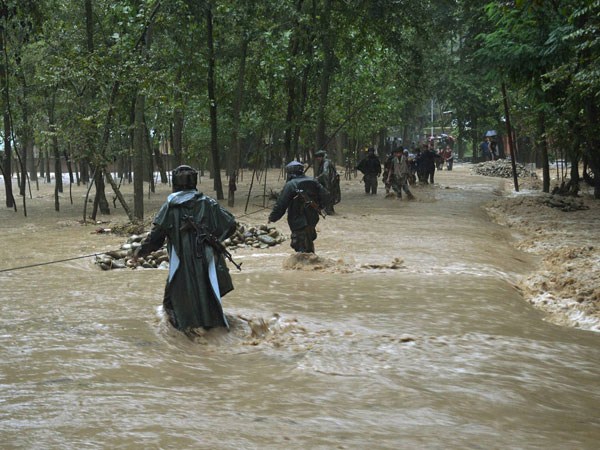 Army personnel rescuing flood-affected villagers