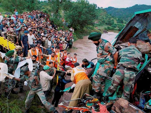 Army soldiers and villagers recover the wreckage