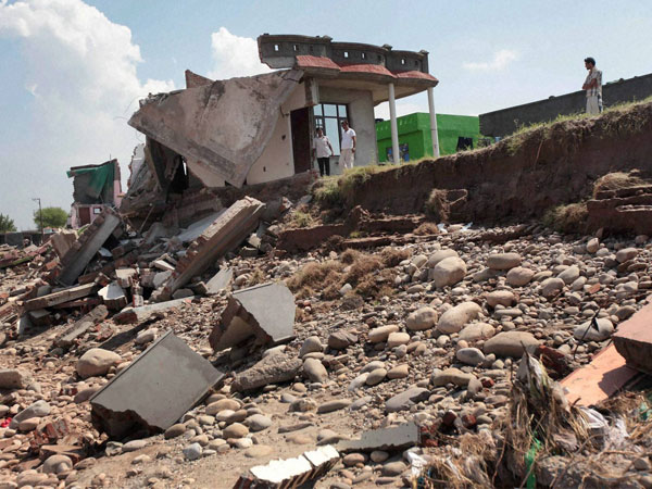 Debris of a flood devastated house on the banks