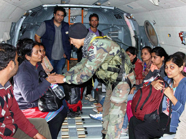 An IAF commando consoles an onboard flood victim