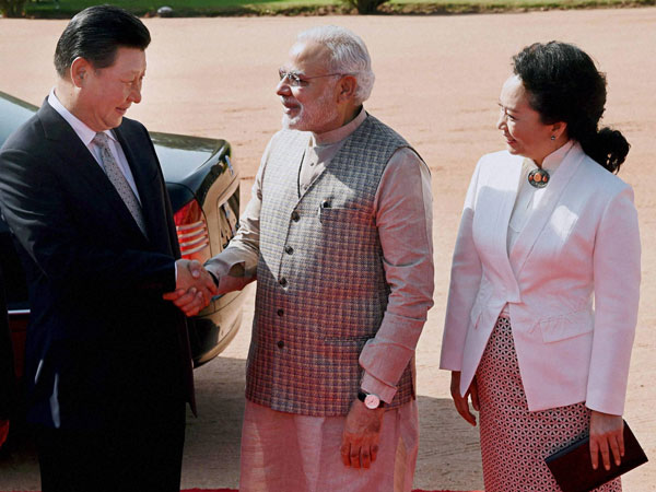 Chinese President Xi Jinping shakes hands with Prime Minister Narendra Modi
