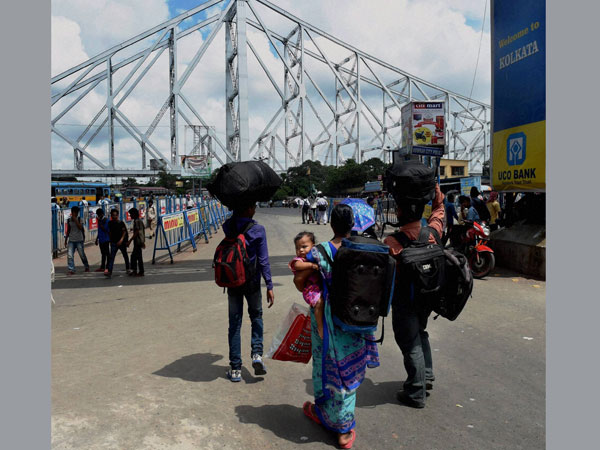 Passengers walk out of the Howrah Station