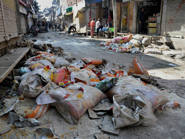 Sacks of food grain lay waste on the road