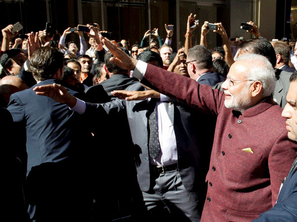 Prime Minister Narendra Modi greets people outside