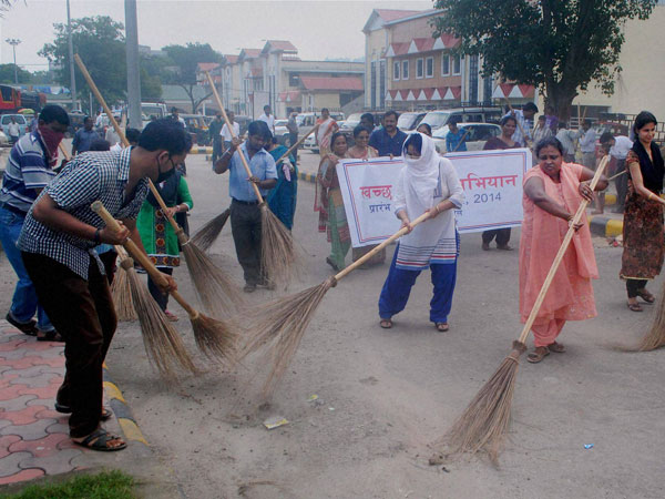 Employees of NF Railwaya sweep a road