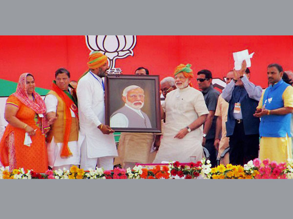 Prime Minister Narendra Modi is presented with his portrait