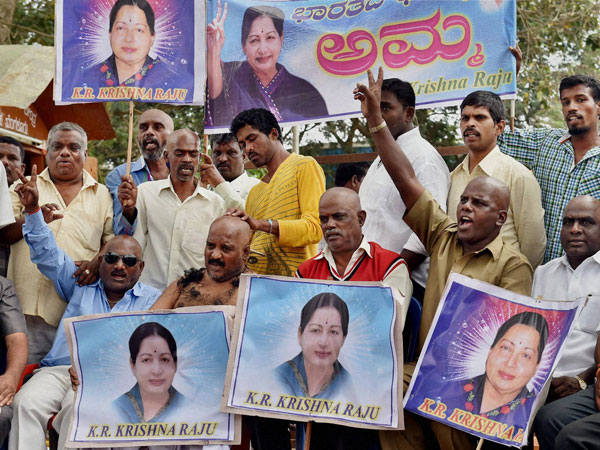 A supporter of AIADMK leader J Jayalalithaa receives tonsure