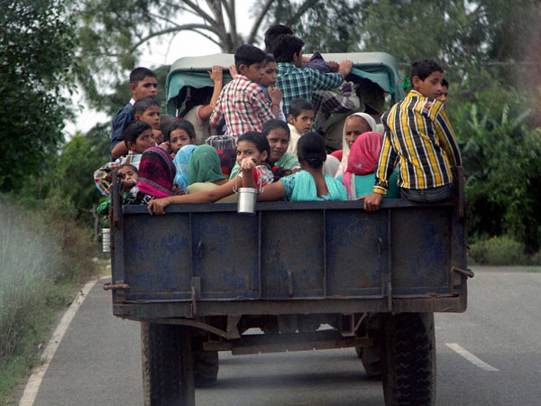 Children and women move to safer places on a tractor 