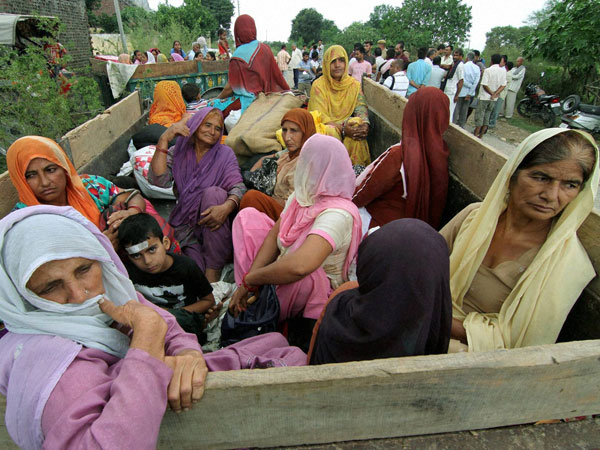 Children and women move to safer places on a tractor 