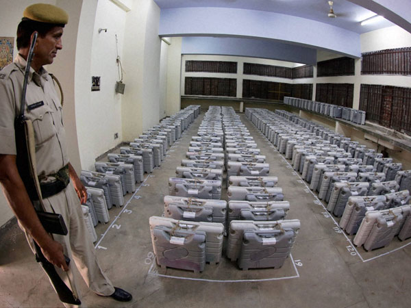 A security personnel keeps a watch over Electronic Voting Machines