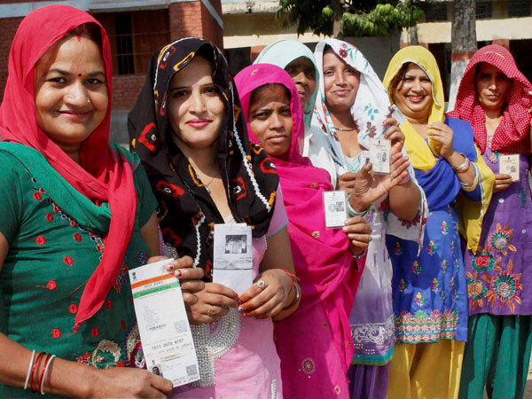 Voters showing their voter identity cards
