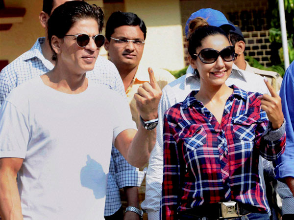 Bollywood actor Shahrukh Khan and his wife Gauri showing their inked finger 