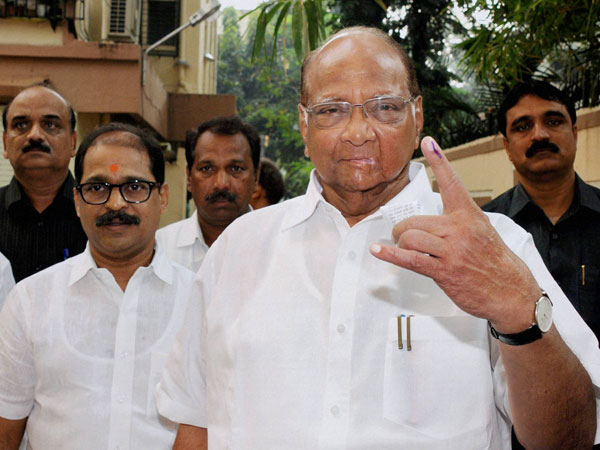 NCP chief Sharad Pawar shows his ink-marked finger
