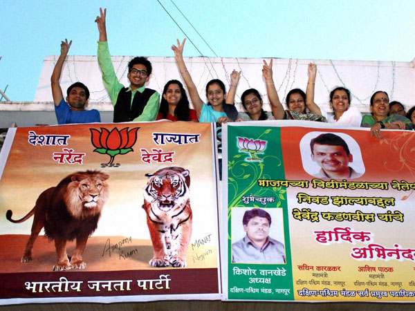 Family members of Devendra Fadnavis hold a banner