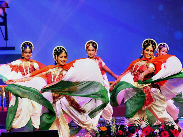 Girls dressed up in Tricolours perform during a function