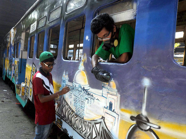 Youngsters paint graffiti at a tram for the 'Sprite Till I Die' event