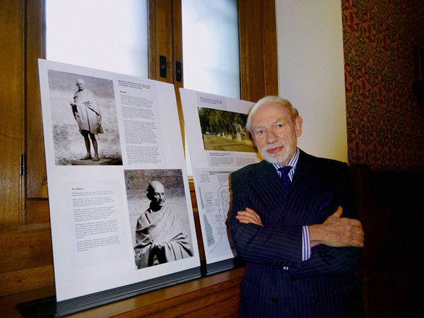 Sculptor Philip Jackson poses with the images