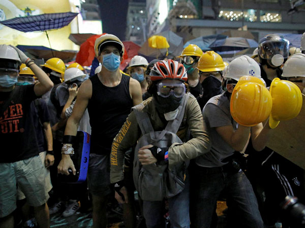 Protesters prepare to push against policemen at an occupied area