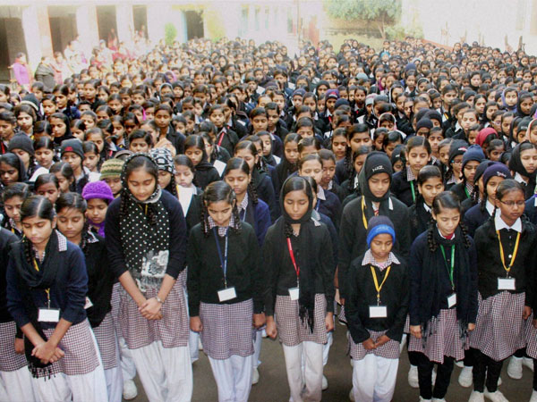 School Children pray for the victims of a Taliban attack