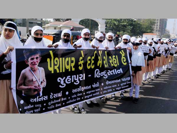 Young girls holds placards with slogans to protest