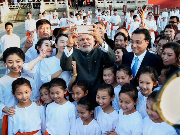 Modi smiles for the camera with Chinese Tai Chi students 