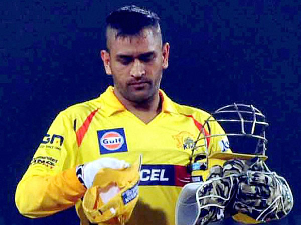 Dhoni with his unique hairstyle