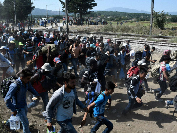 Migrants move along at the border town of Idomeni, northern Greece
