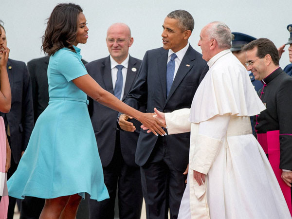 First lady Michelle Obama, accompanied by President Barack Obama, greet Pope Francis upon his arrival at Andrews Air Force Base