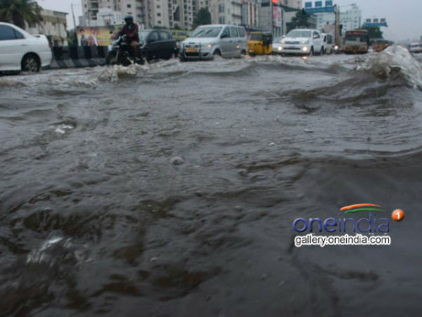 Vehicles move on a submerged road in Chennai