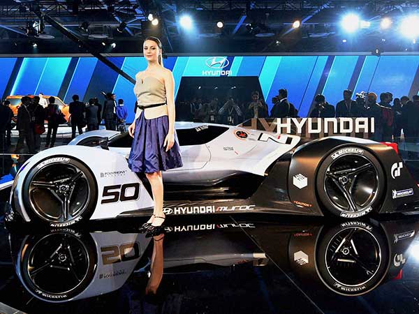 A model poses in front of sports car