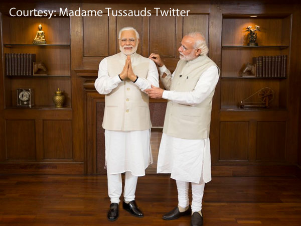 Modi adjusts the sleeves of his wax figurine