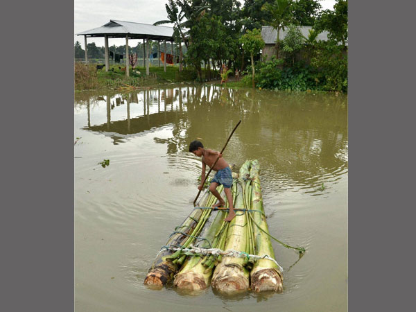 Boy wades through floodwaters