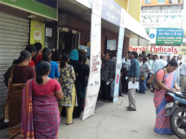 Anxious public waiting outside a bank
