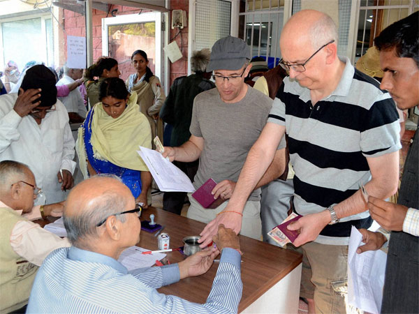 Tourists get indelible ink applied