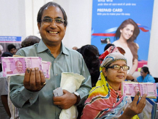 Customers display inked fingers, new notes