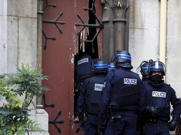 French police officers storm a church French police officers storm a church