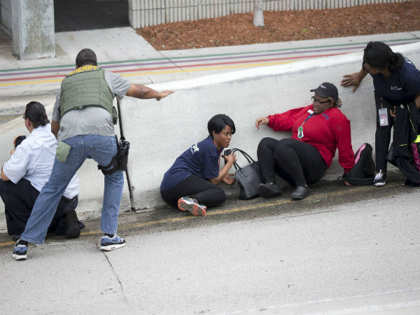 Bystanders lay low outside the airport