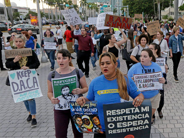 Protesters chant slogans against President Donald Trump's executive order on immigration in Miami. Protesters chant slogans against President Donald Trump's executive order on immigration in Miami.