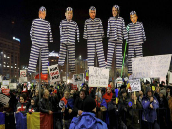 Demonstrators carry puppets