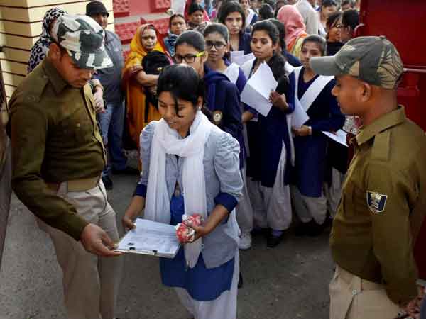 Students being checked before entering exam hall