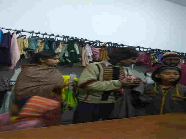 A family checks the clothes at Neki Ki Dukan