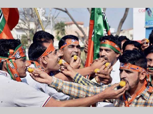 Supporters distribute sweets 