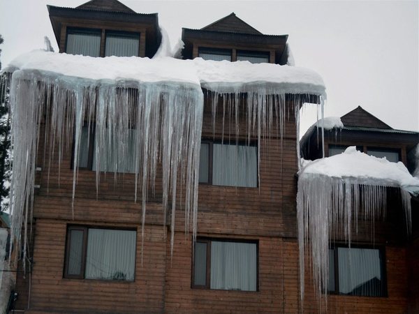 Long icicles hanging from a roof at a tourist resort in Gulmarg