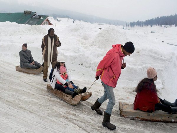  Tourists enjoy snow sledge ride